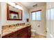 Bathroom with granite countertop and dark wood cabinets at 7024 E Montana Pl, Denver, CO 80224