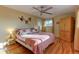 Spacious bedroom with hardwood floors and ceiling fan at 7024 E Montana Pl, Denver, CO 80224