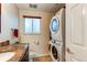 Convenient laundry room with stackable washer/dryer at 7024 E Montana Pl, Denver, CO 80224