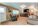 Living room with brick fireplace, comfortable seating, and large TV at 7024 E Montana Pl, Denver, CO 80224