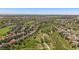 Aerial view of the neighborhood with sprawling lawns, mature trees, and community walking paths at 7912 S Buchanan Way, Aurora, CO 80016