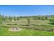 The backyard view showcases a picturesque scene of lush greenery and trees, creating a private and serene atmosphere at 7912 S Buchanan Way, Aurora, CO 80016
