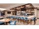 Elegant bar area featuring a well-stocked bar, comfortable seating, and modern design at 7912 S Buchanan Way, Aurora, CO 80016