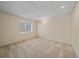 Finished carpeted basement offers a blank canvas with a small window for natural light at 7912 S Buchanan Way, Aurora, CO 80016