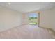 Finished basement room with plush carpeting, sliding glass doors to backyard, and natural light at 7912 S Buchanan Way, Aurora, CO 80016