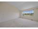 This sunlit bedroom offers a large window with picturesque views of the outdoors, creating a serene atmosphere at 7912 S Buchanan Way, Aurora, CO 80016