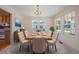 Formal dining room featuring a chandelier and large windows for abundant natural light at 7912 S Buchanan Way, Aurora, CO 80016
