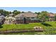 Back exterior view of home showcasing the brick and siding facade and lush landscaping at 7912 S Buchanan Way, Aurora, CO 80016