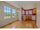 Eat-in kitchen with hardwood floors, large windows, and a dining area at 7912 S Buchanan Way, Aurora, CO 80016