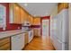 Bright kitchen with light wood cabinetry, white appliances, and a functional layout at 7912 S Buchanan Way, Aurora, CO 80016