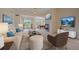 Bright living room featuring a fireplace, plush seating, and access to a balcony at 7912 S Buchanan Way, Aurora, CO 80016