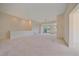 Spacious living room with neutral carpet, open layout, and lots of natural light at 7912 S Buchanan Way, Aurora, CO 80016