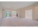 Bright living room featuring fireplace, ceiling fan, and access to a balcony at 7912 S Buchanan Way, Aurora, CO 80016