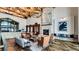 Inviting lobby area featuring stone fireplace, comfortable seating, and wood beam ceilings at 7912 S Buchanan Way, Aurora, CO 80016