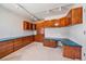 Spacious office featuring custom wooden built-ins, ample storage, and stylish countertops at 7912 S Buchanan Way, Aurora, CO 80016