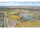 An aerial view of a recreation area with a lake, walking trails, and sports fields at 19047 Randolph Pl, Denver, CO 80249