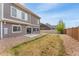 A well maintained backyard featuring neutral fencing, gravel, and a concrete patio at 19047 Randolph Pl, Denver, CO 80249