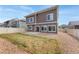 A spacious backyard featuring neutral fencing, gravel, and a concrete patio at 19047 Randolph Pl, Denver, CO 80249