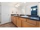 Bathroom features a double vanity with light wood cabinets, and a large mirror at 19047 Randolph Pl, Denver, CO 80249