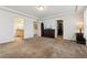 Bright bedroom featuring doors to a bathroom and closet, neutral walls and carpet, and a dark dresser at 19047 Randolph Pl, Denver, CO 80249