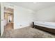 Bedroom features neutral walls, carpet, and view into the hallway featuring a full size bed at 19047 Randolph Pl, Denver, CO 80249