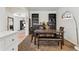 Elegant dining room with seating for six, bookshelves, and lots of natural light at 19047 Randolph Pl, Denver, CO 80249