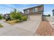 Two-story home featuring an attached two-car garage and landscaped front yard at 19047 Randolph Pl, Denver, CO 80249
