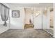This hallway features neutral walls, carpeting, and a large mirror at 19047 Randolph Pl, Denver, CO 80249