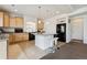 Open kitchen with island, bar stools, and ample counter space with modern appliances at 19047 Randolph Pl, Denver, CO 80249