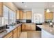 Bright kitchen features wood cabinets, granite countertops, and stainless steel appliances at 19047 Randolph Pl, Denver, CO 80249