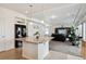 Open concept kitchen with granite island overlooking a cozy living room area at 19047 Randolph Pl, Denver, CO 80249