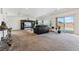 Expansive living room features neutral carpet, modern decor and sliding door access to the yard at 19047 Randolph Pl, Denver, CO 80249