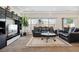 Comfortable living room with carpeted floors, large windows and modern furniture at 19047 Randolph Pl, Denver, CO 80249
