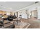 Spacious living room featuring plush seating, and an open layout to kitchen at 19047 Randolph Pl, Denver, CO 80249