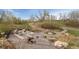 A unique play area is composed of logs, stumps, and boulders for climbing and exploration at 19047 Randolph Pl, Denver, CO 80249