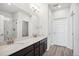 An elegant bathroom featuring a double sink vanity with bright mirror and plenty of cabinet space at 487 Interlocken Blvd # 303, Broomfield, CO 80021