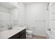 Bathroom featuring a vanity with dark brown cabinets, white countertop, and a shower with white tiled walls at 487 Interlocken Blvd # 303, Broomfield, CO 80021