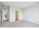 A cozy bedroom with fresh carpeting, featuring two doors and a bright window at 487 Interlocken Blvd # 303, Broomfield, CO 80021