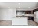 Bright kitchen features a large island, stainless steel appliances, sleek cabinetry, and an adjacent dining area at 487 Interlocken Blvd # 303, Broomfield, CO 80021