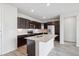 Spacious kitchen showcasing dark cabinets, stainless steel appliances, an island with a sink and ample counter space at 487 Interlocken Blvd # 303, Broomfield, CO 80021
