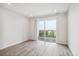 Open living area with a sliding glass door to balcony and a large window, providing ample natural light at 487 Interlocken Blvd # 303, Broomfield, CO 80021