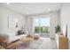 Bright living room features a modern sofa, stylish rug, and a sliding glass door leading to a balcony at 487 Interlocken Blvd # 303, Broomfield, CO 80021