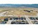 Neighborhood aerial view features houses with modern designs in an open landscape setting with distant mountains at 8480 Arriba Dr, Littleton, CO 80125