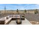 Beautiful backyard patio area with comfortable seating and a cozy fire pit for outdoor entertaining at 8480 Arriba Dr, Littleton, CO 80125