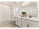 Bright bathroom with a double vanity, shower, tub, and modern fixtures at 8480 Arriba Dr, Littleton, CO 80125
