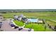 Aerial view of community pool, clubhouse, lounge chairs, parking and green space at 8480 Arriba Dr, Littleton, CO 80125