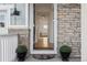 Warm entryway with decorative plants, leading into a naturally lit living space, and hardwood floors at 8480 Arriba Dr, Littleton, CO 80125