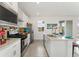 Modern kitchen featuring stainless steel appliances, a center island, and ample counter space at 8480 Arriba Dr, Littleton, CO 80125