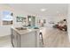 Bright, open kitchen featuring a large island with seating and a view into the living room at 8480 Arriba Dr, Littleton, CO 80125