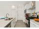 Modern kitchen featuring stainless steel appliances, granite countertops, and white cabinetry at 8480 Arriba Dr, Littleton, CO 80125